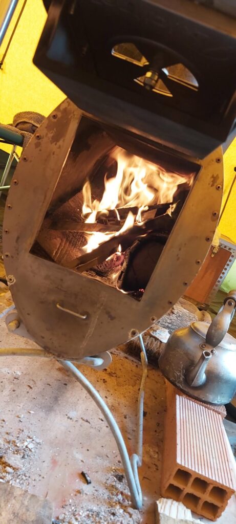 The flames from the wood fire in the Tentipi stove as the dutch oven gets up to temperature