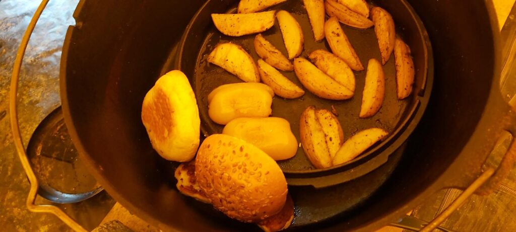 Dutch oven - One pot cooking at its best - seasoned wedges, drizzled with olive oil, pepper, halloumi and the sesame bun warming before serving.